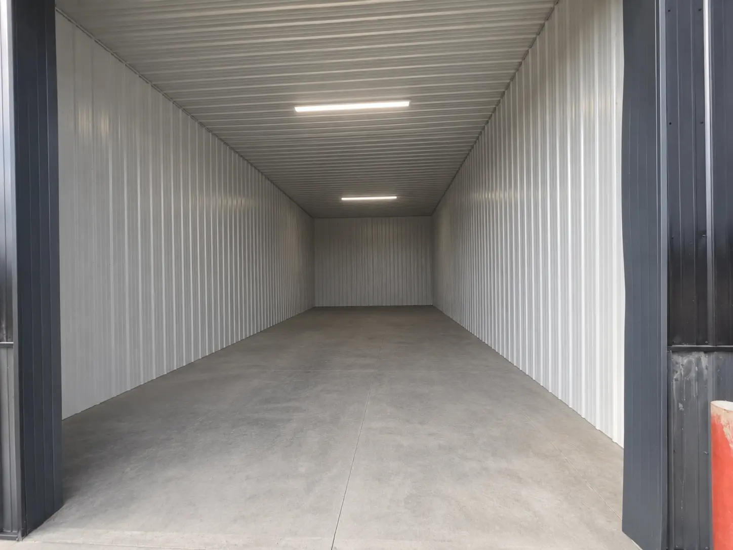 Oversized enclosed storage unit with high ceilings and large overhead door